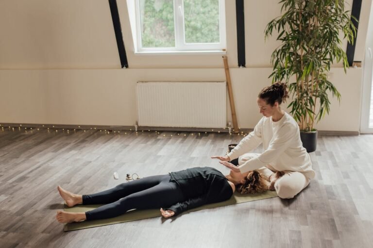 Woman Sitting beside Woman Lying on the Floor