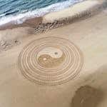 Yin Yang Symbol On Brown Beach Sand